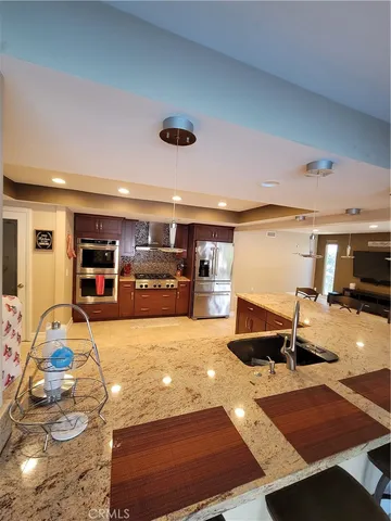 a living room with furniture a wooden floor and window