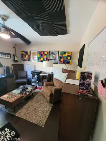 a living room with furniture and a book shelf