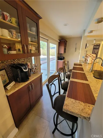 a living room with furniture and two windows
