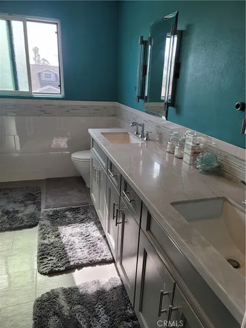 a bathroom with a tub sink and mirror