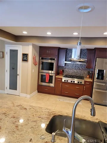 a kitchen with sink refrigerator and stove