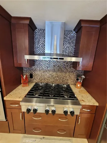 a kitchen with wooden cabinets and a stove top oven