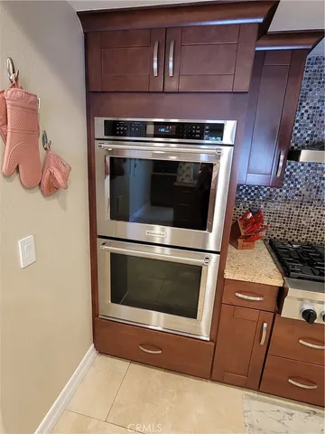 a stove top oven sitting inside of a kitchen
