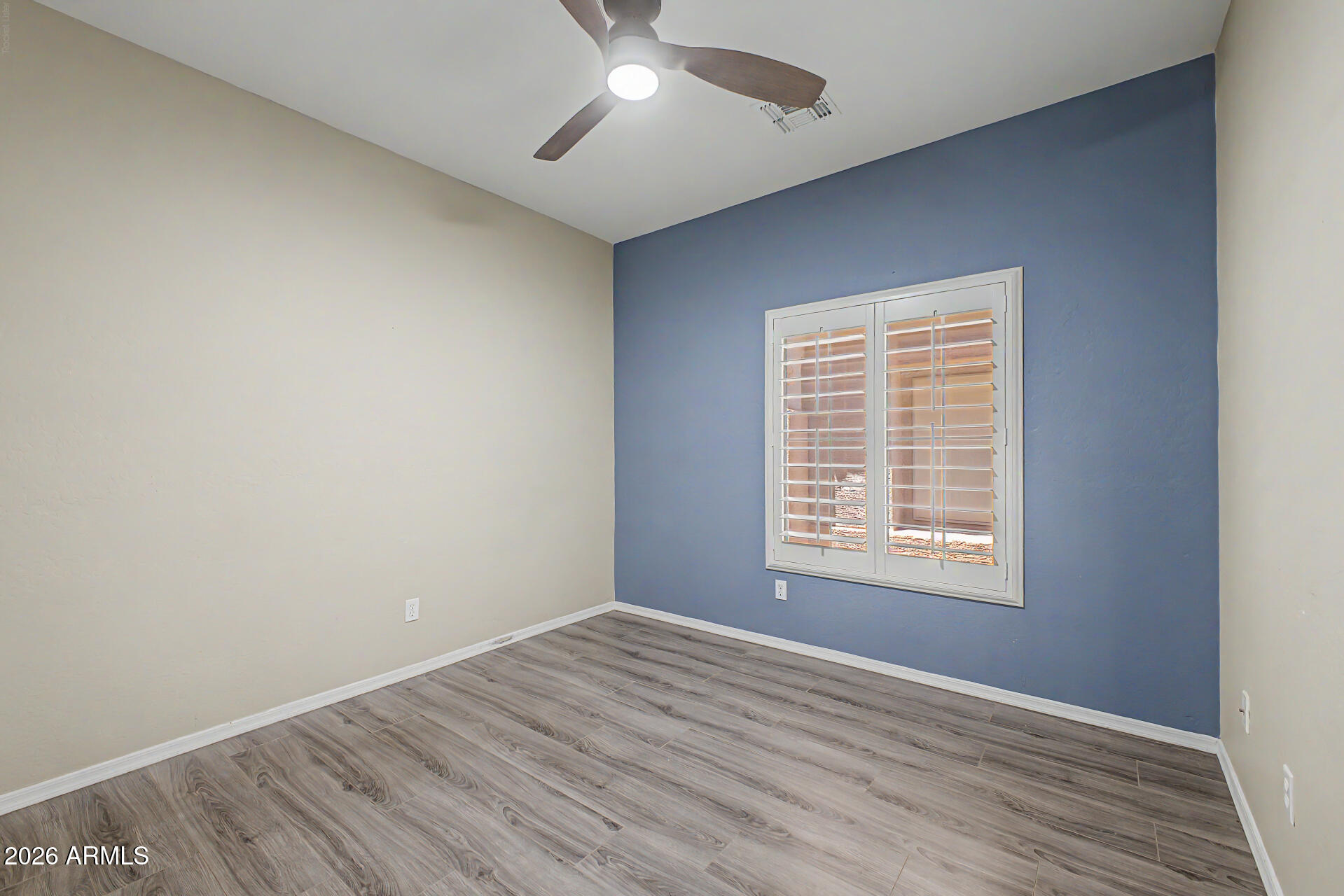 2600 East Springfield Place, Unit 109 Chandler, AZ 85286 - Photo 20 of 38 an empty room with wooden floor and windows