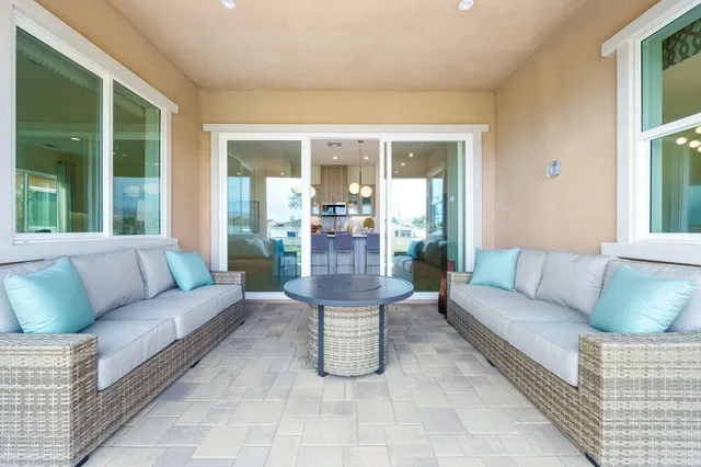 a bedroom with a bed chandelier and a window