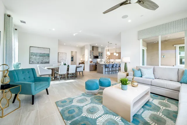 a kitchen with a dining table cabinets stainless steel appliances and a chandelier