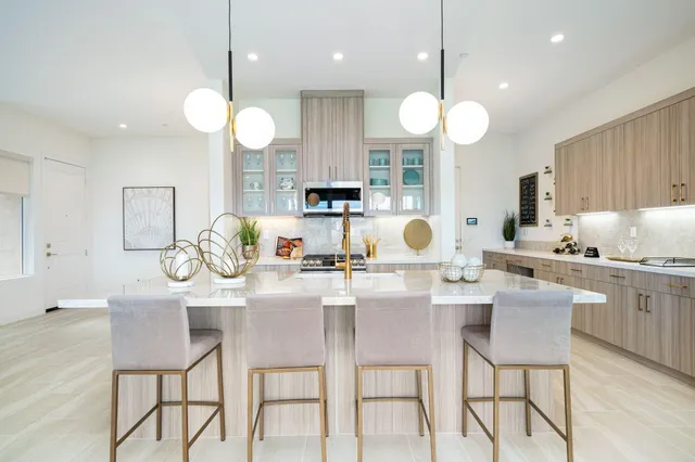a kitchen with a sink a stove and cabinets