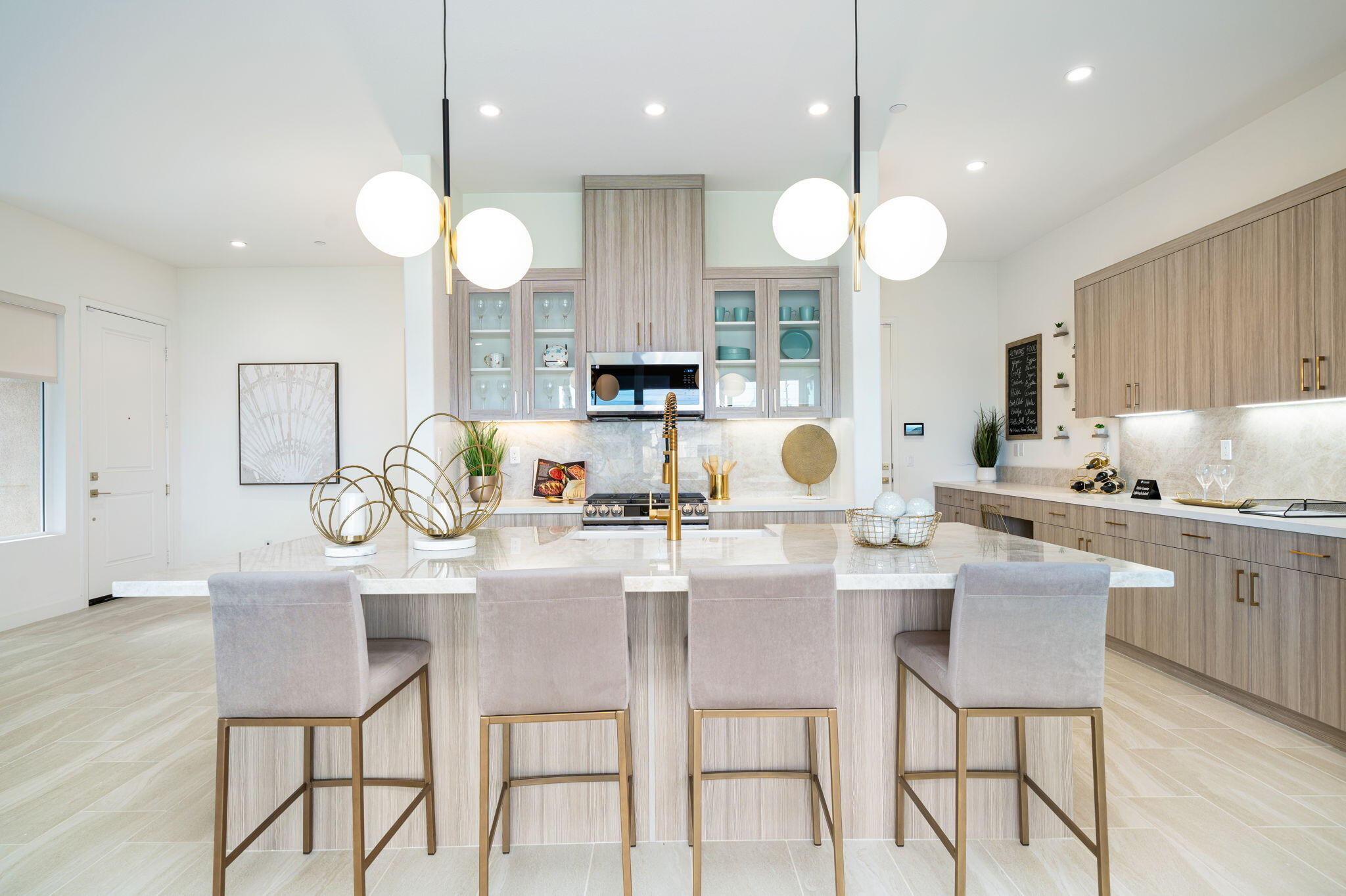 82725 Ryan Way Indio, CA 92201 - Photo 5 of 31 a kitchen with a dining table cabinets stainless steel appliances and a chandelier
