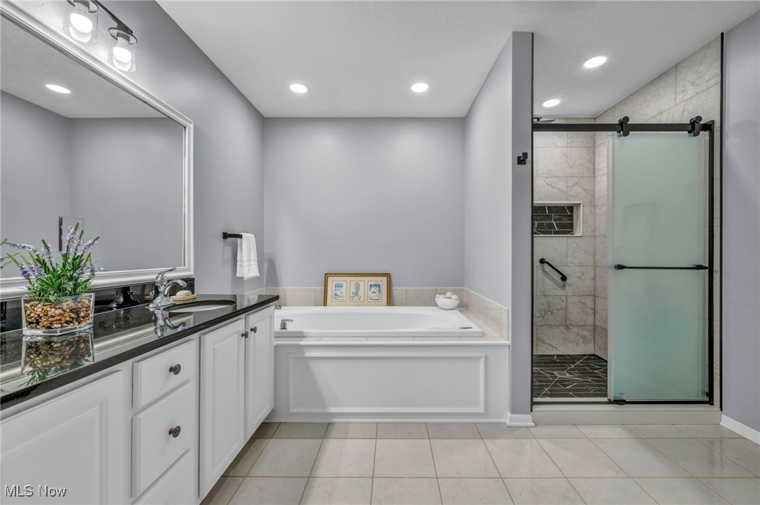 30257 Center Ridge Road Westlake, OH 44145 - Photo 30 of 42 Bathroom with a garden tub, vanity, recessed lighting, a stall shower, and light tile patterned floors