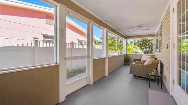 a balcony with furniture and a large window