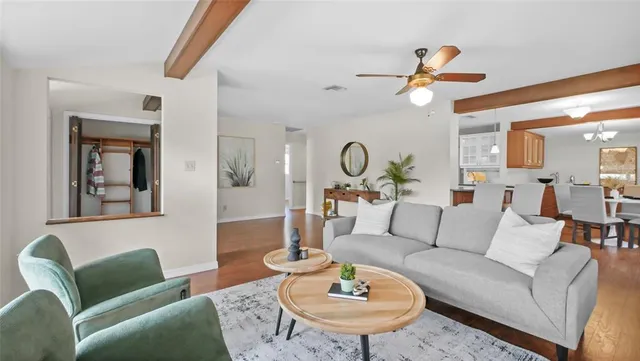 a living room with furniture kitchen view and a table