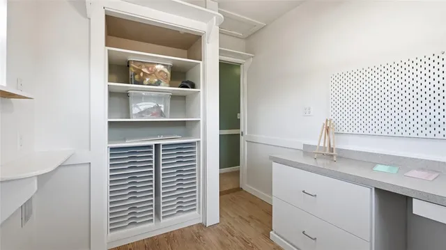 a view of house with a yard and potted plants