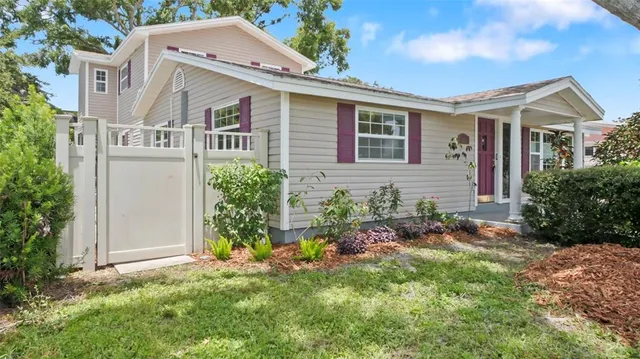 a view of a house with backyard and sitting area