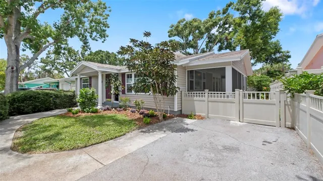 a view of a patio with table and chairs and potted plants with wooden floor and fence