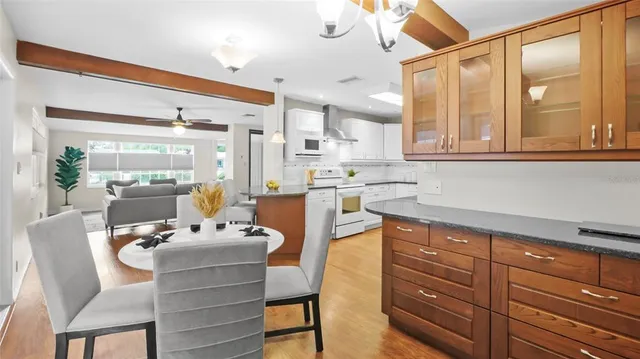 a dining room with furniture and a large window