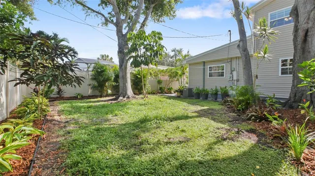 an aerial view of a house with yard