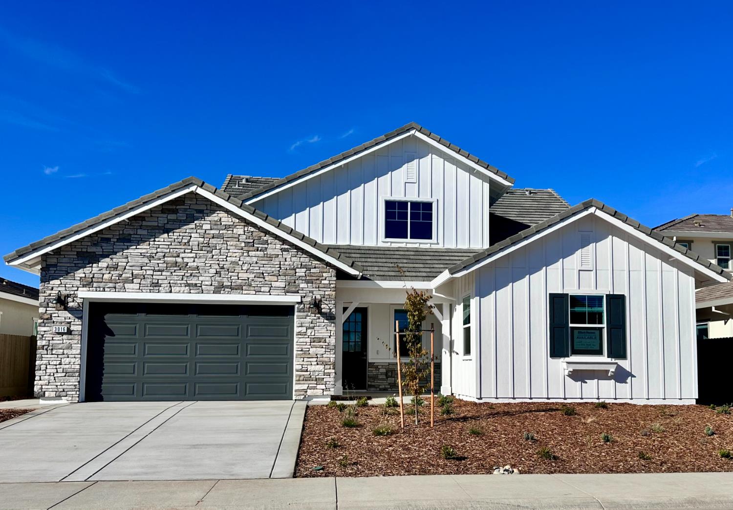 a front view of a house with garage