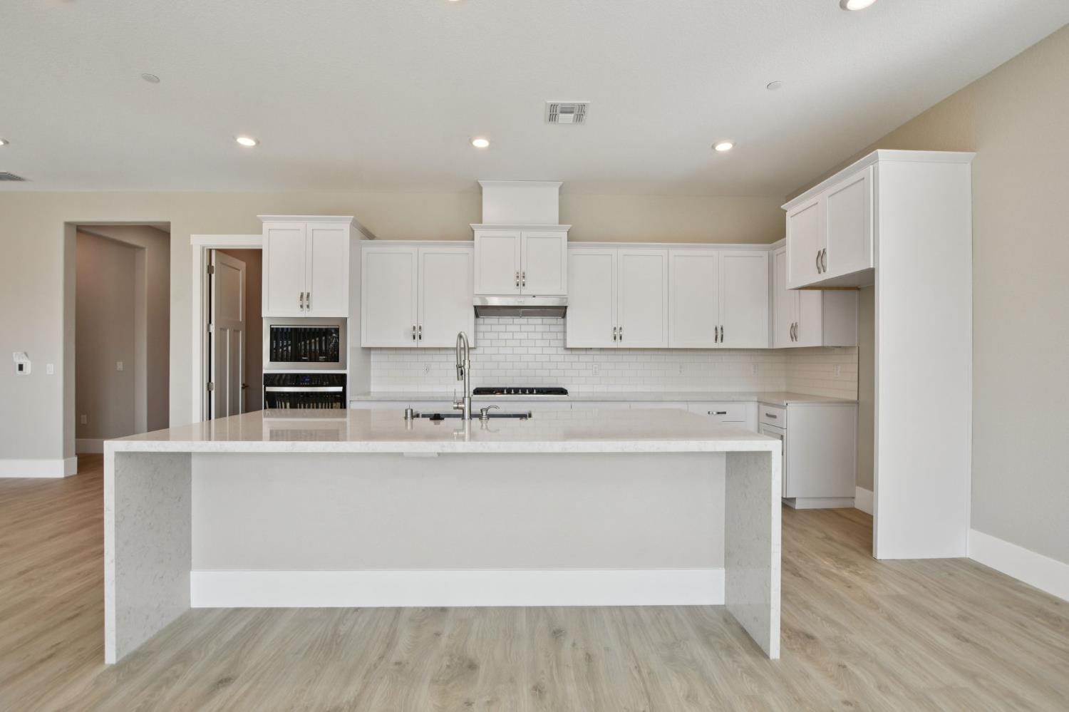3016 Pocosol Way Rancho Cordova, CA 95742 - Photo 14 of 37 a large kitchen with stainless steel appliances a refrigerator and a stove top oven