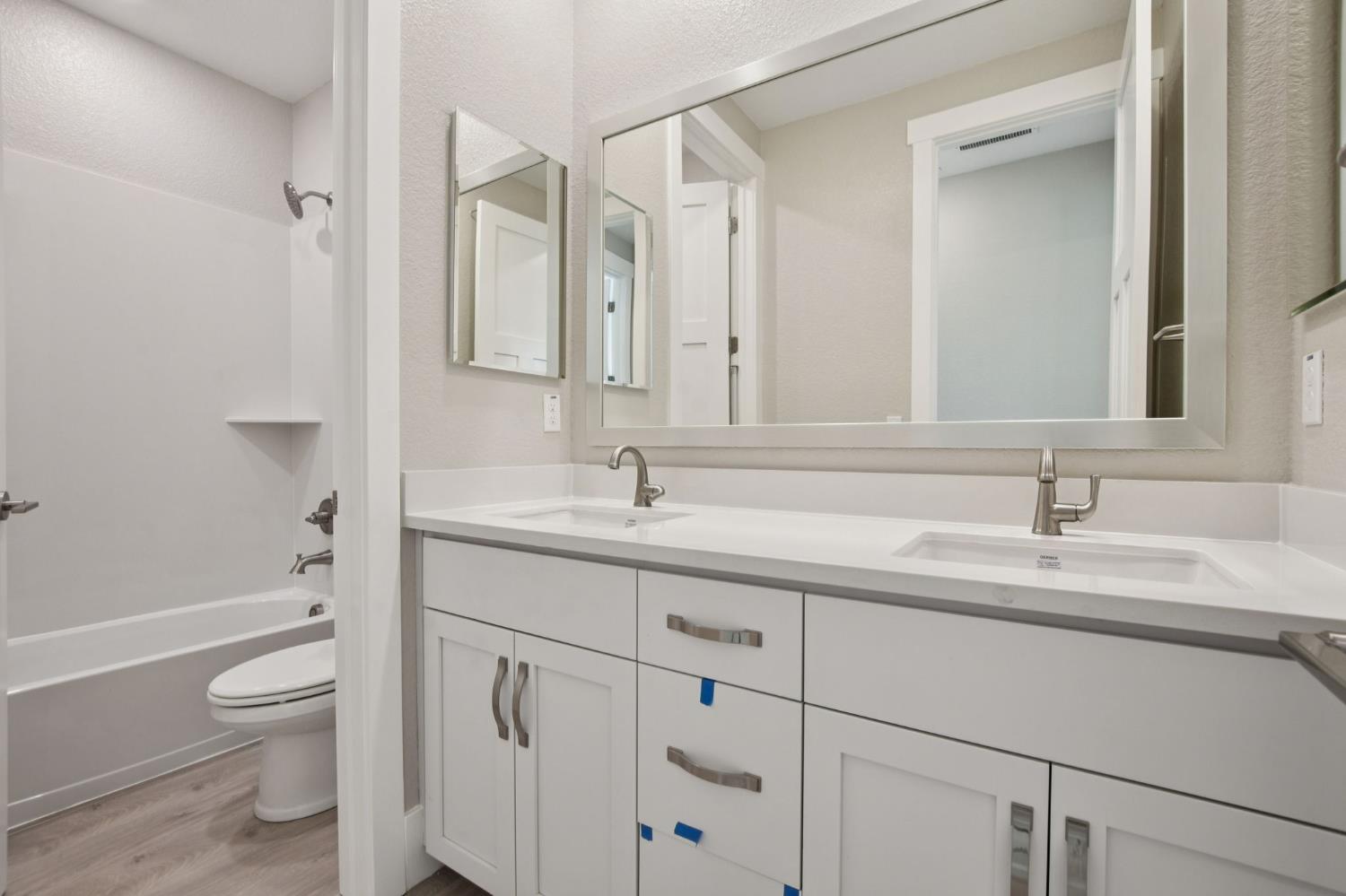 3016 Pocosol Way Rancho Cordova, CA 95742 - Photo 27 of 37 a bathroom with a granite countertop sink a toilet and a bathtub