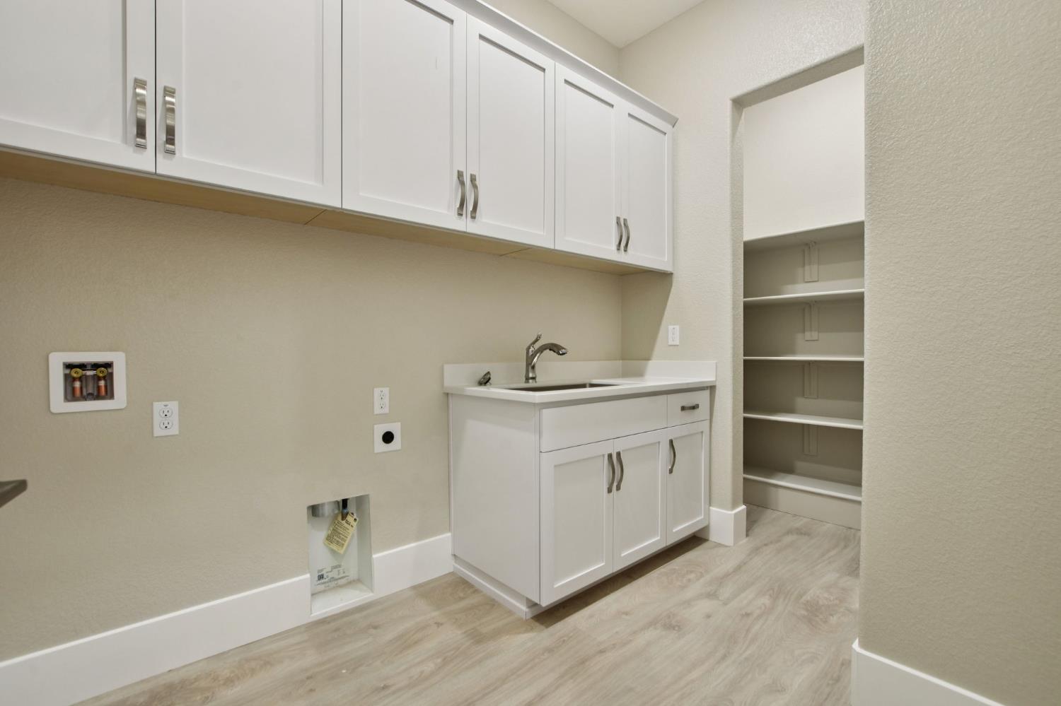 3016 Pocosol Way Rancho Cordova, CA 95742 - Photo 31 of 37 a utility room with cabinets washer and dryer