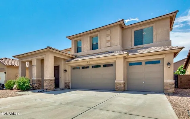 a front view of a house with a garage