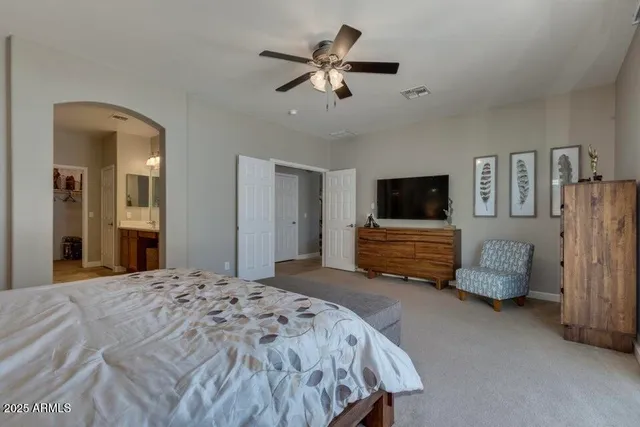 a bedroom with bed and tv