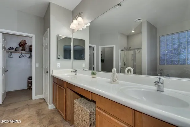a bathroom with a double vanity sink and a mirror