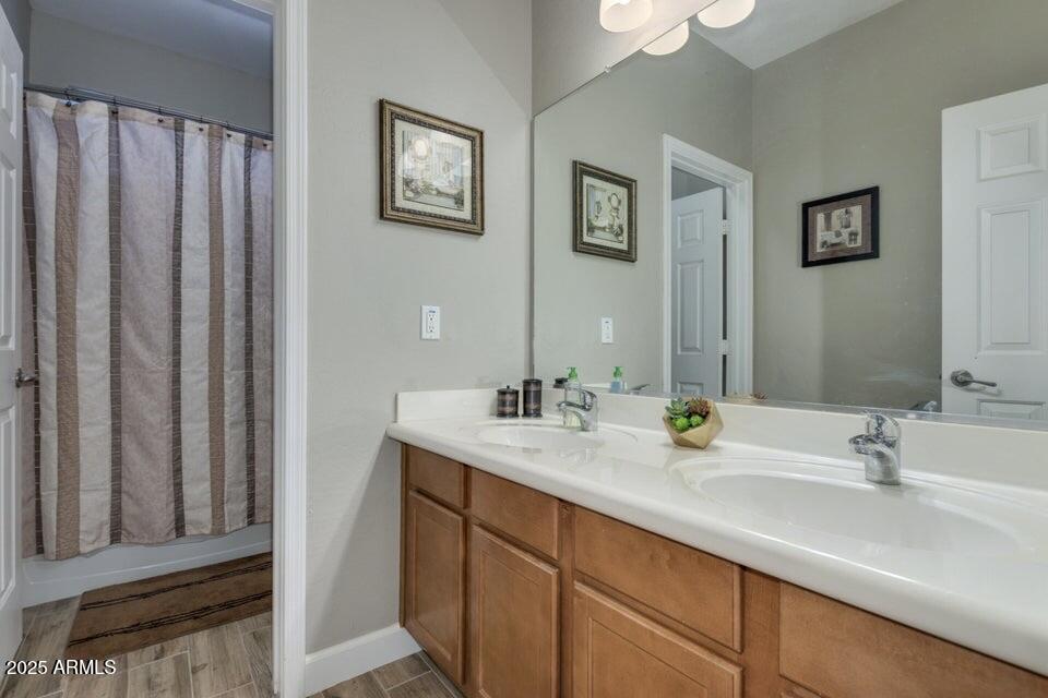 46073 West Morning View Lane Maricopa, AZ 85139 - Photo 23 of 36 a bathroom with a double vanity sink and a mirror
