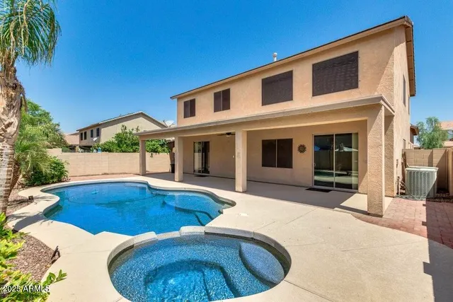 a view of a house with swimming pool and porch