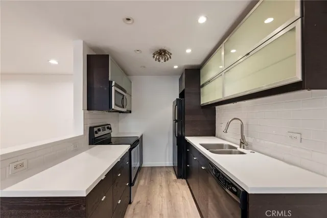a kitchen with a sink and a stove top oven