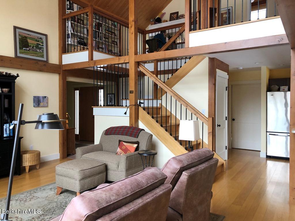 469 Boulger Road Stamford, VT 05352 - Photo 2 of 37 a view of livingroom with furniture staircase and windows