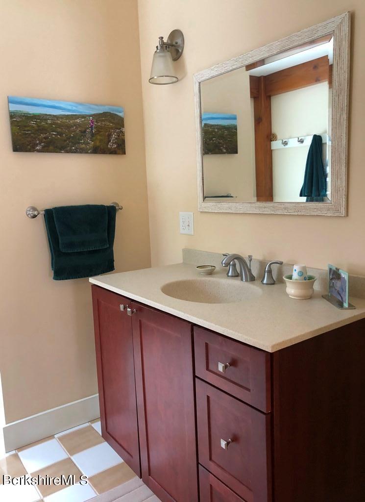 469 Boulger Road Stamford, VT 05352 - Photo 14 of 37 a bathroom with a sink a light fixture and a mirror
