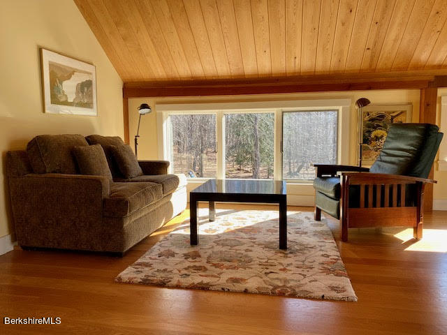 469 Boulger Road Stamford, VT 05352 - Photo 18 of 37 a living room with furniture and a large window