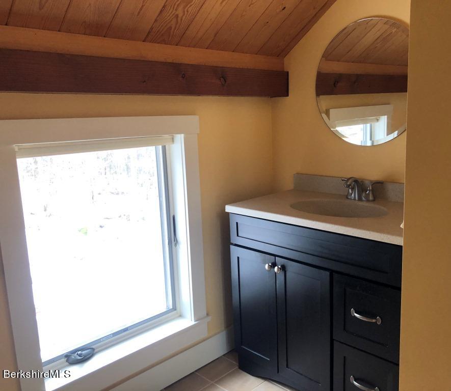 469 Boulger Road Stamford, VT 05352 - Photo 21 of 37 a bathroom with a sink and a mirror
