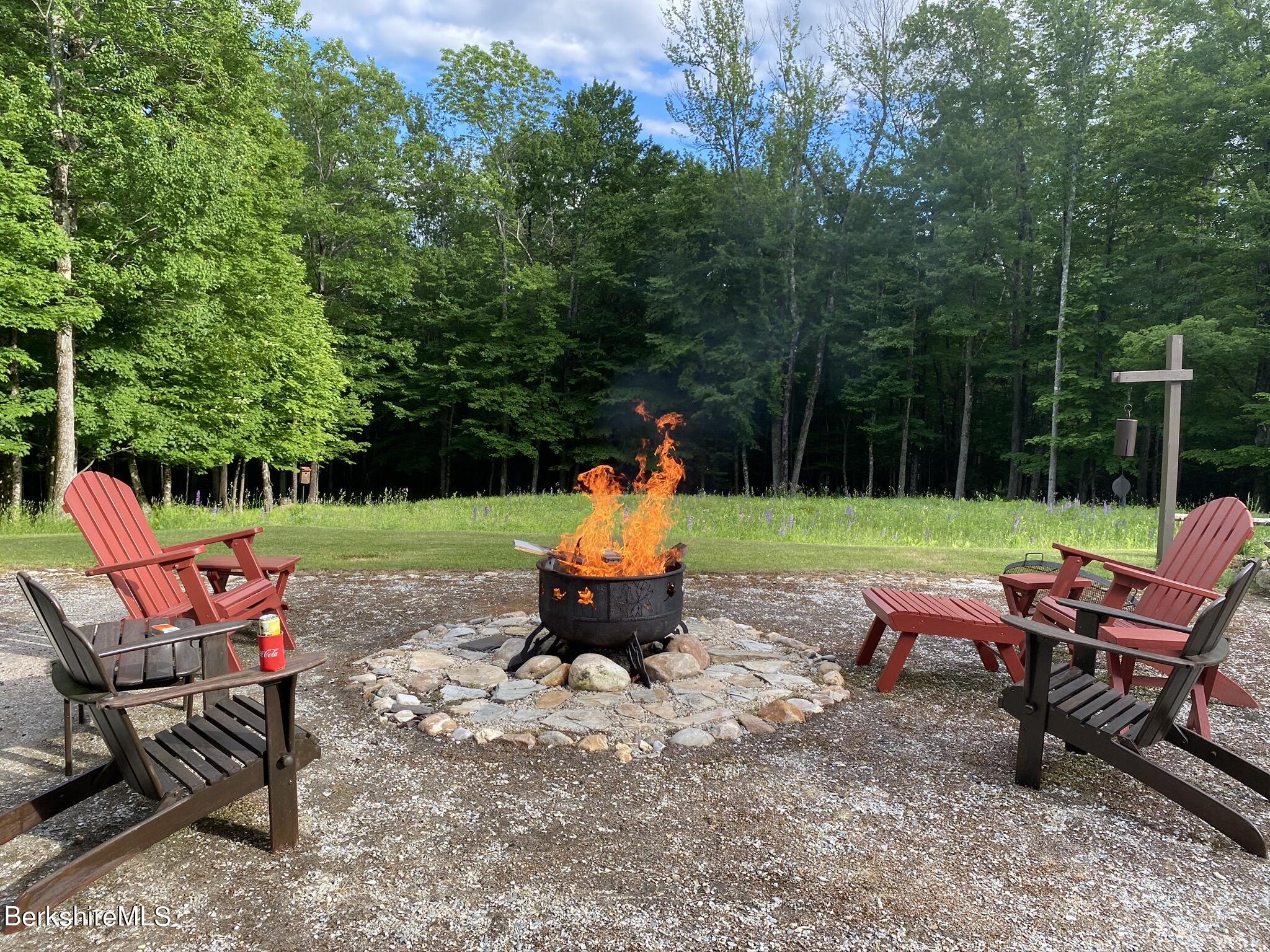 469 Boulger Road Stamford, VT 05352 - Photo 27 of 37 a backyard of a house with fire pit and outdoor seating