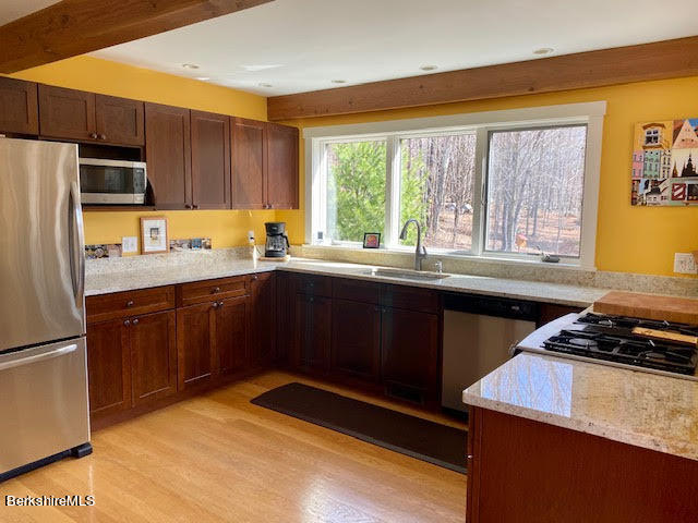 469 Boulger Road Stamford, VT 05352 - Photo 6 of 37 a kitchen with a sink a stove a refrigerator cabinets and a window
