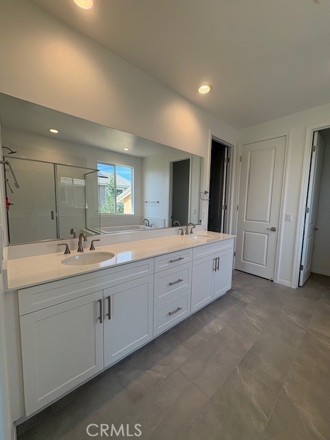 30495 Servin Lane Menifee, CA 92584 - Photo 21 of 22 a spacious bathroom with a double vanity sink and a mirror