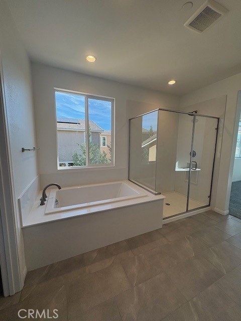 30495 Servin Lane Menifee, CA 92584 - Photo 22 of 22 a spacious bathroom with a bathtub and a shower