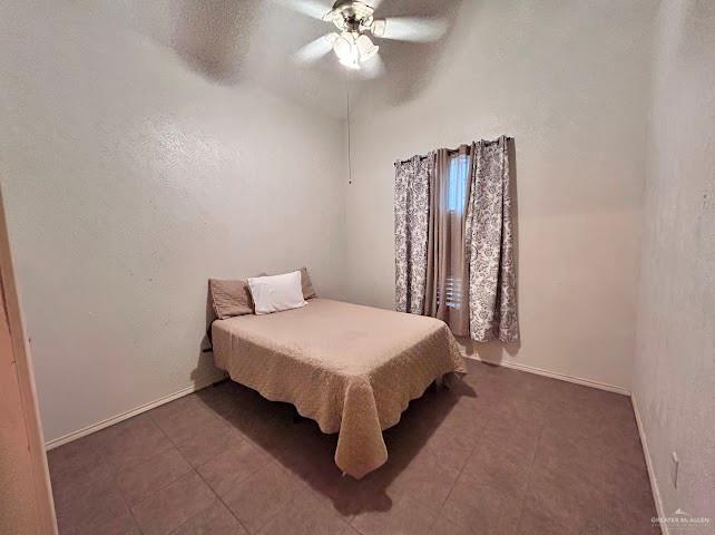 21325 Norene Drive Edcouch, TX 78538 - Photo 14 of 15 a bed room with a bed and a chandelier