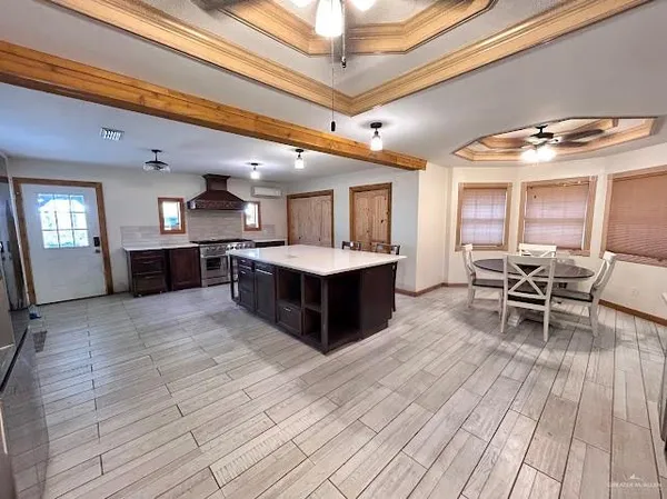 a large room with wooden floor and furniture