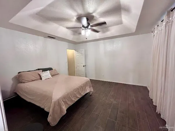 a bedroom with a bed and a chandelier