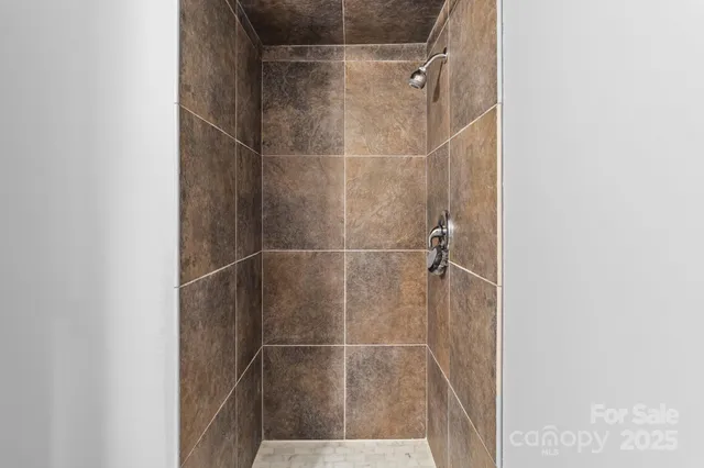 a bathroom with a glass door shower