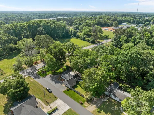 an aerial view of a house with a yard