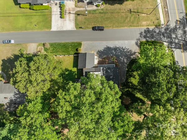 an aerial view of a house with a yard