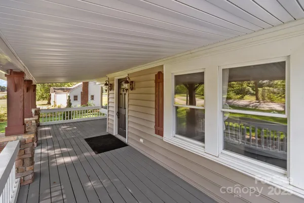 a view of outdoor space with wooden floor and windows