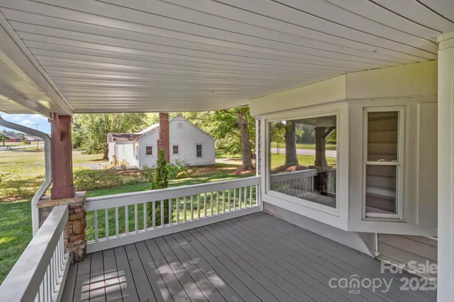 a view of a porch with wooden floor