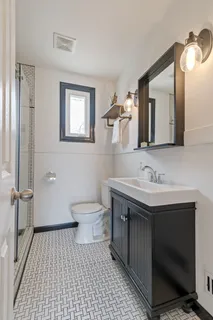 a bathroom with a sink a toilet and mirror
