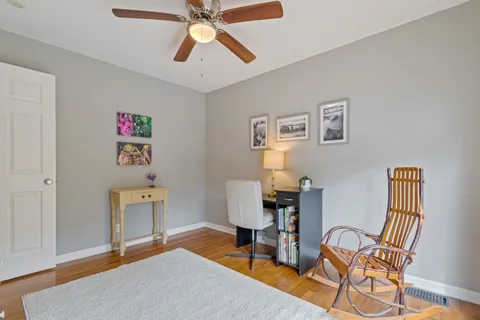 a workspace room with furniture and wooden floor