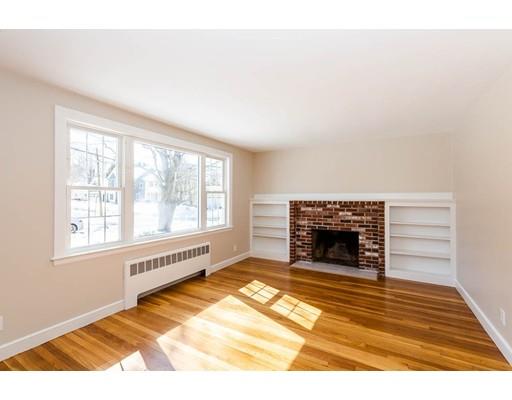 7 Roosevelt Road Lexington, MA 02421 - Photo 5 of 28 a view of an empty room with a window and fire place