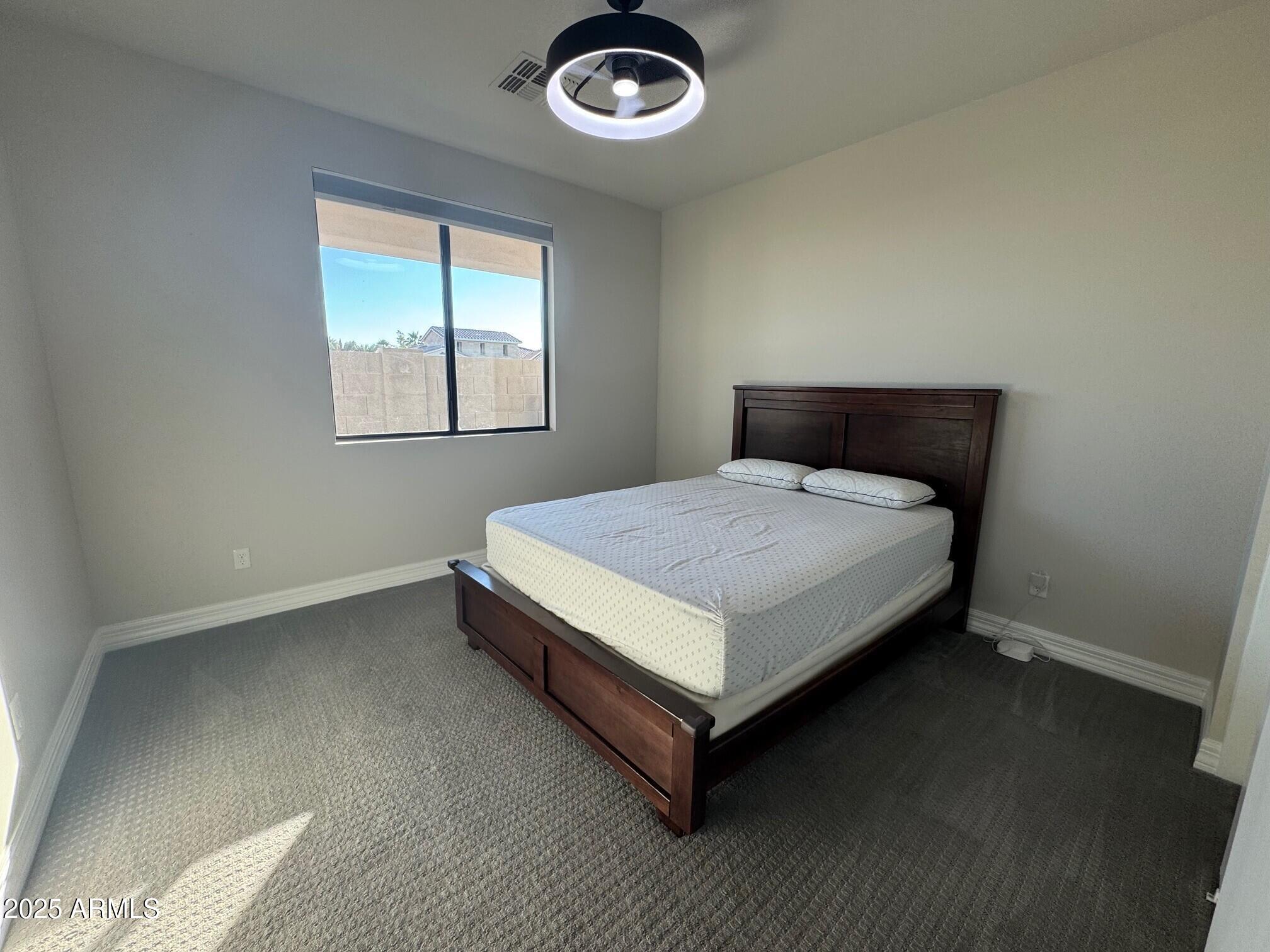 4350 East Kings Avenue Phoenix, AZ 85032 - Photo 11 of 15 a bed sitting in a bedroom next to a window